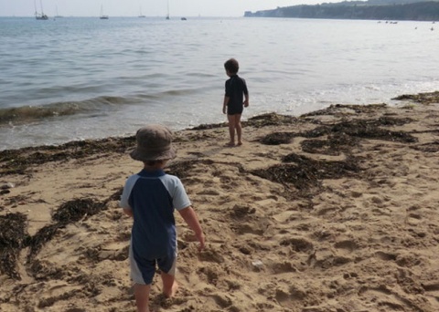 Two young children on the beach at Studland