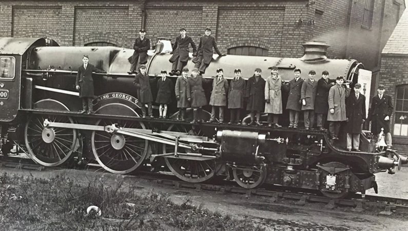 Black & white photo of people standing on a train